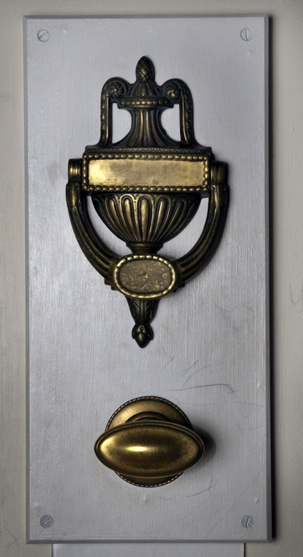 Door Knocker Ornate brass door knocker. Curved handle with lots of fluting and carved details.