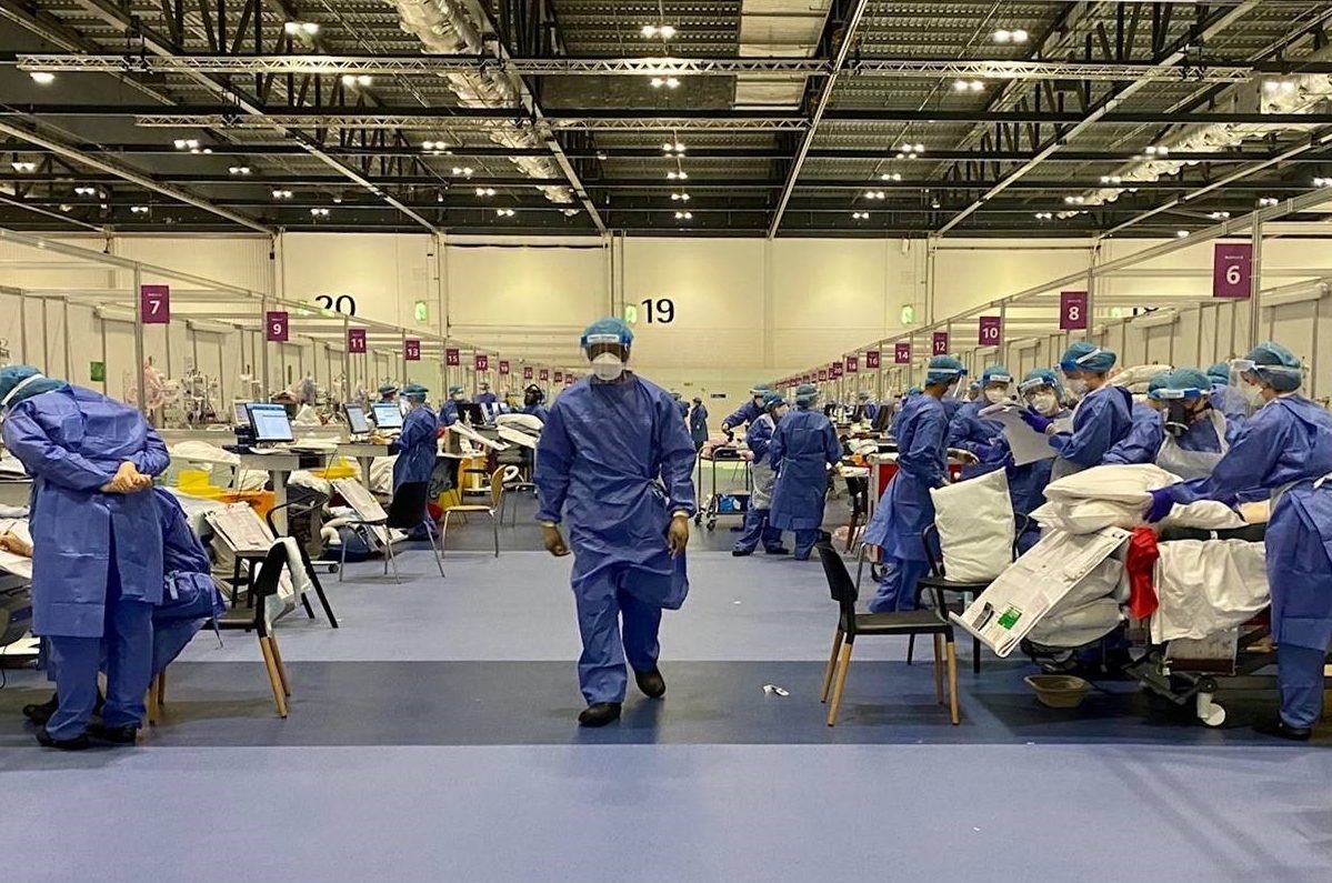 Nurses and doctors in full PPE tend patients in NHS Nightingale Hospital