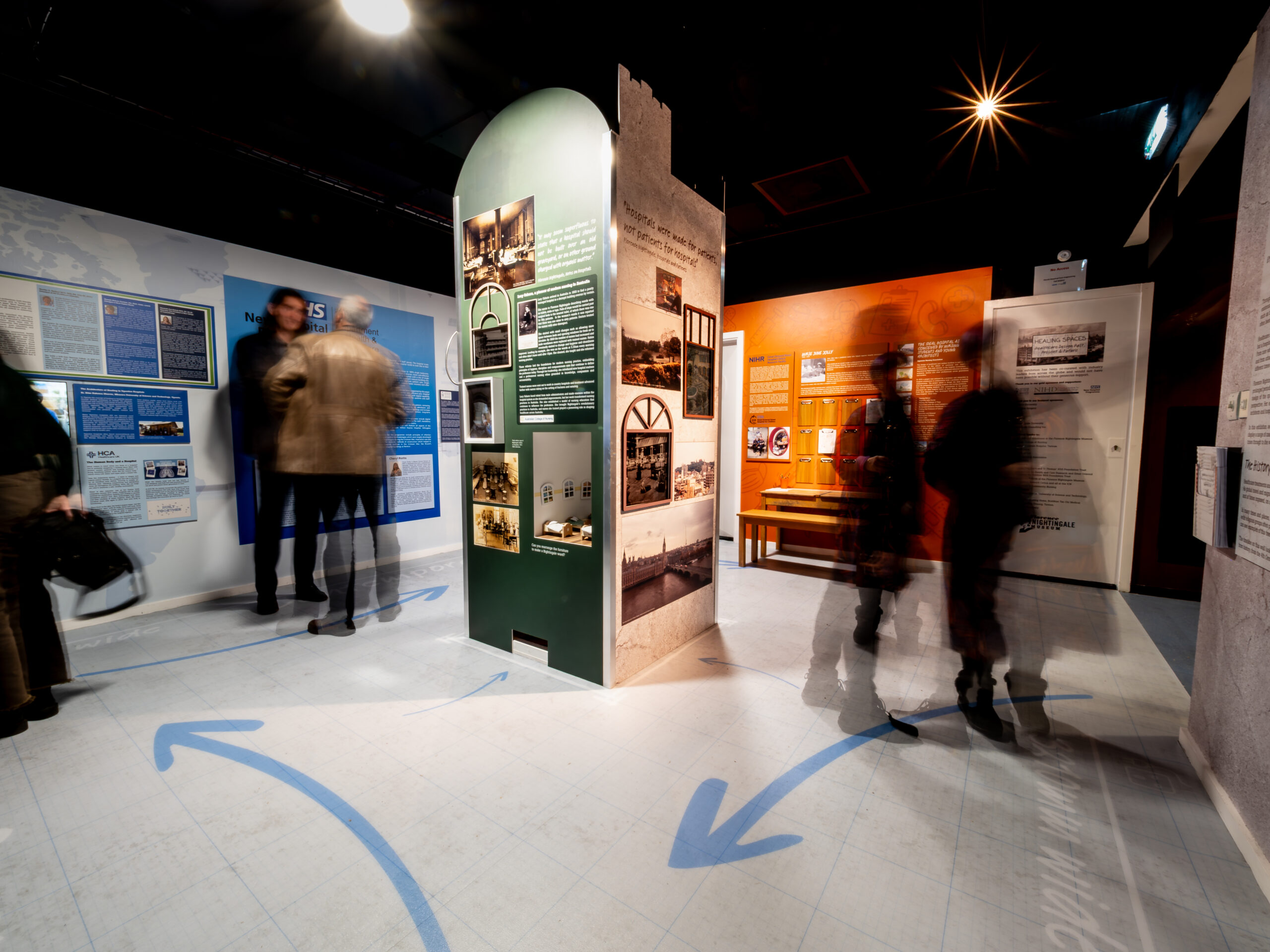 Photograph of the Healing Spaces exhibition space, with people viewing the exhibition