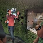 Michael Parthenope Talk a man in a red shirts gesticulates as he talks about an object on display