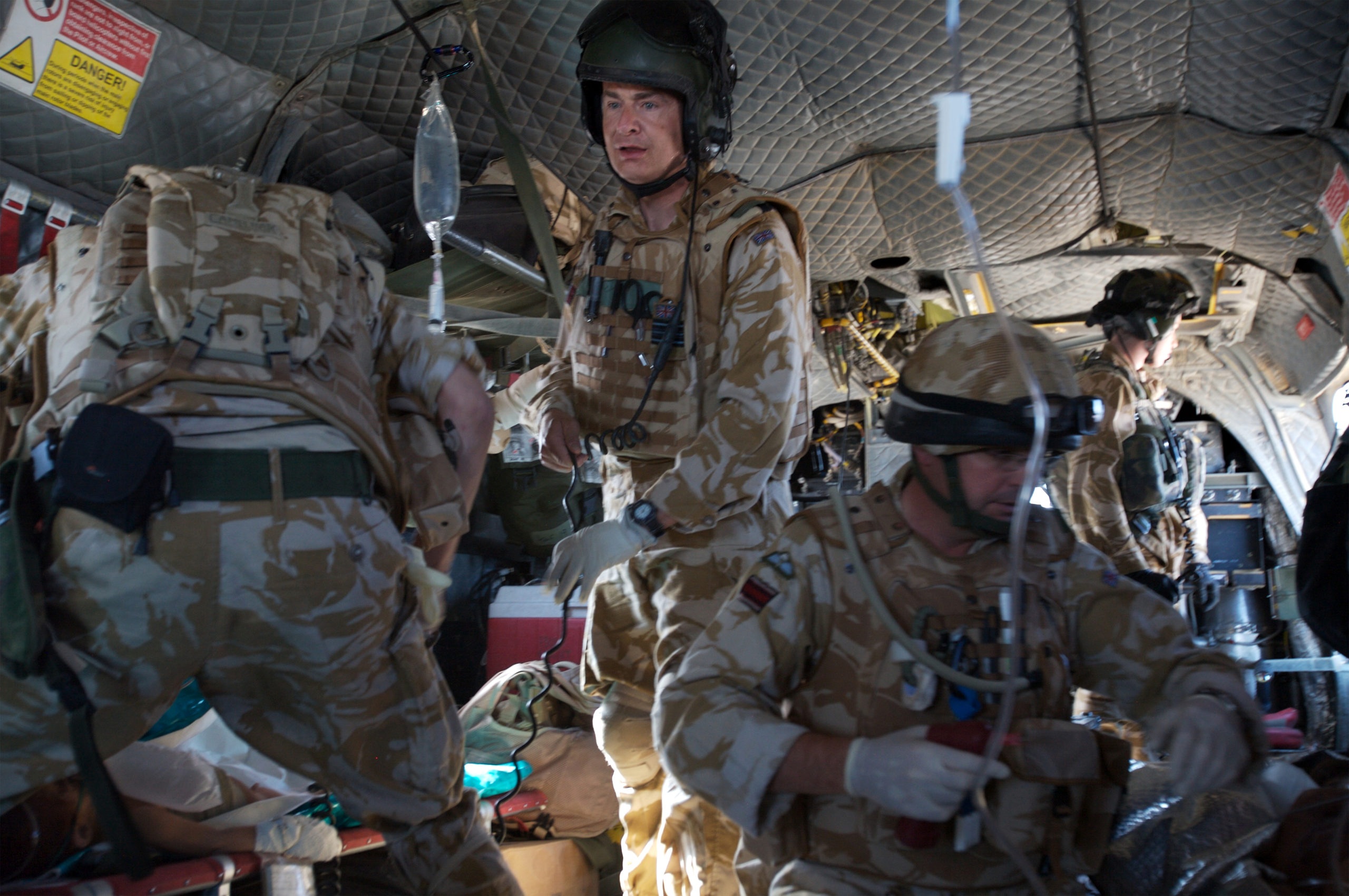 Nurses work in the back of a helicopter